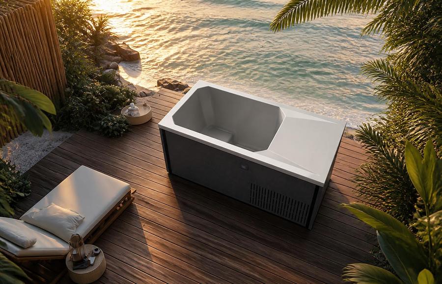 Cold plunge tub on a wooden deck overlooking the ocean at sunset